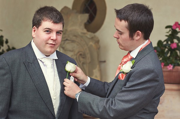 The best man helping the groom get ready
