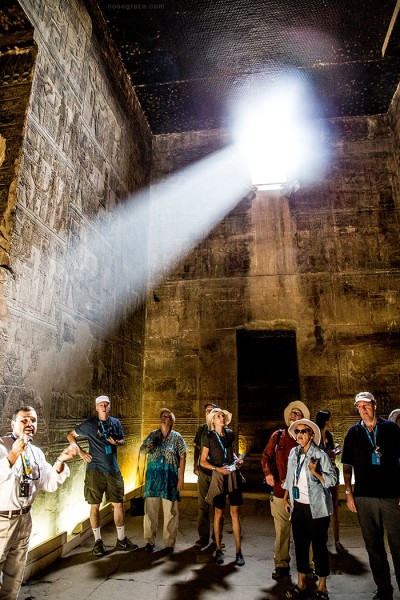 People gathered inside the temple, with light streaming through the window
