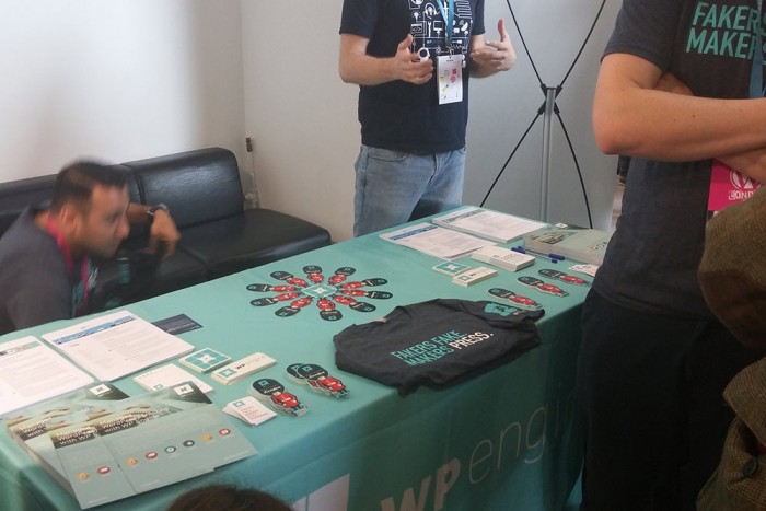 The WP Engine table at WordCamp - full of stickers, t-shirts and brochures
