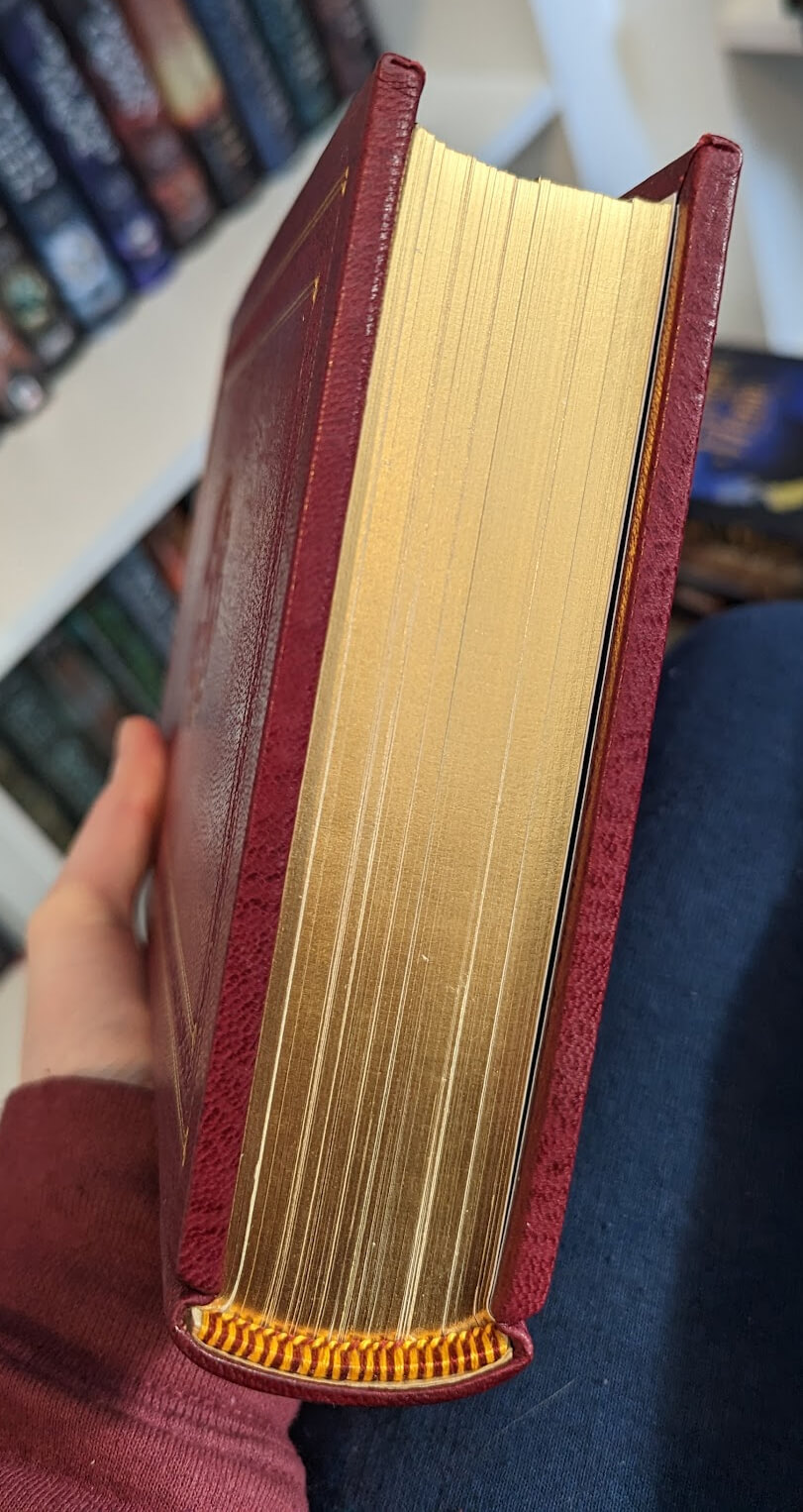 Photo of the gilded edges of a leather-bound book, and a tailband